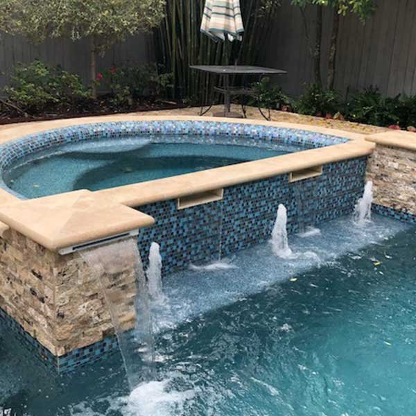 Custom Water Feature - Bubblers next to a Spa Addition Designed by Houston Pool Renovations